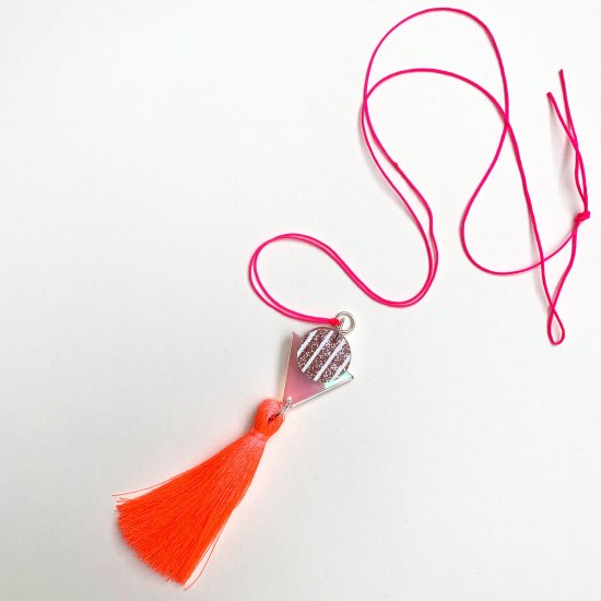 product shot of neon coral tassel pendant