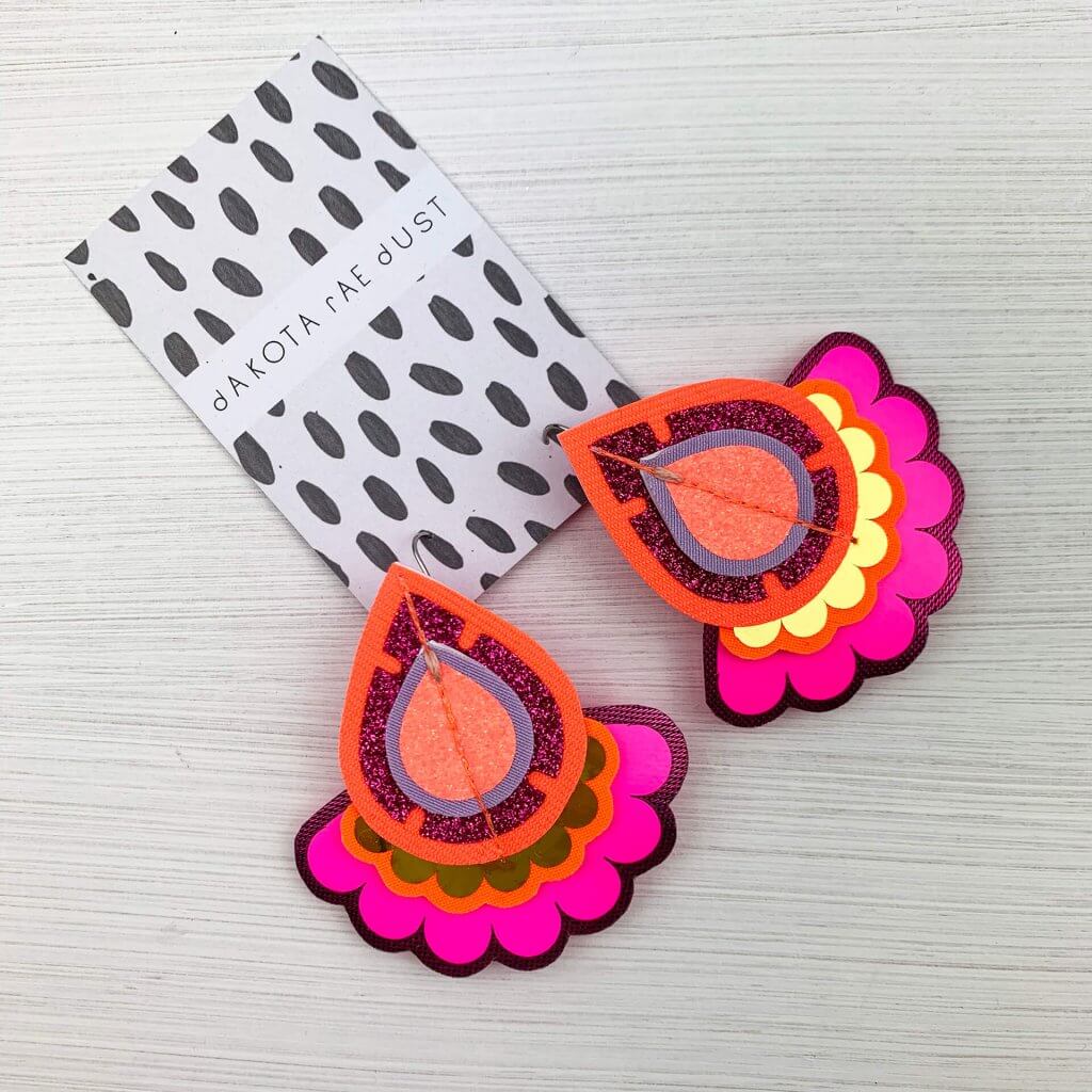 Colourful oversize earrings in fluoro pink orange and gold