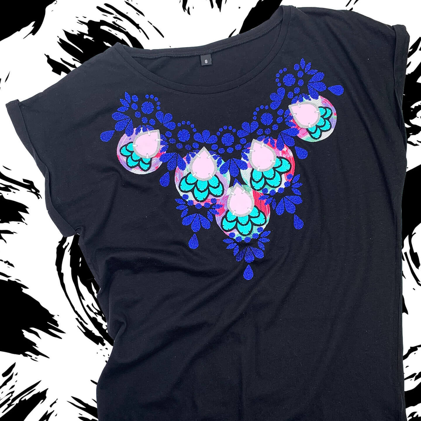 A black slim fit embellished t-shirt in black with a glittery blue, turquoise and lavender print.