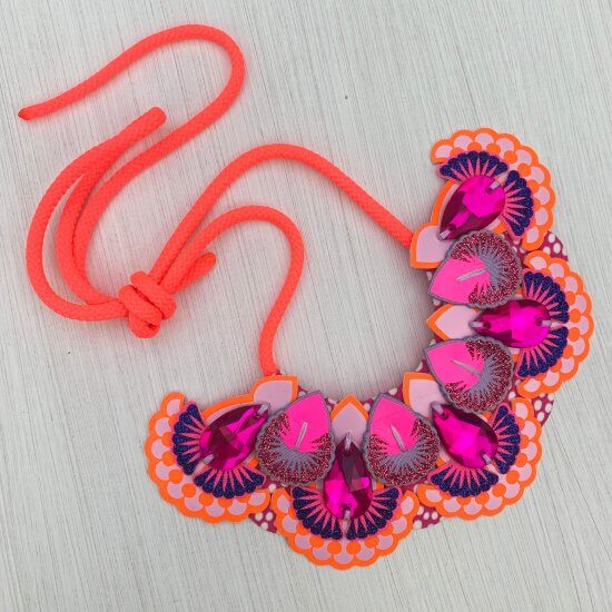 A neon coral, pink and orange Statement Jewel Necklace with neon coral cord and a bib featuring 5 bright pink teardrop shaped jewels