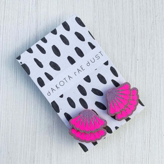 a pair of lilac and fluorescent pink frill stud earrings mounted on a black and white patterned, dakota rae dust branded card
