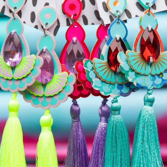 A row of colourful jewel adorned statement tassel earrings